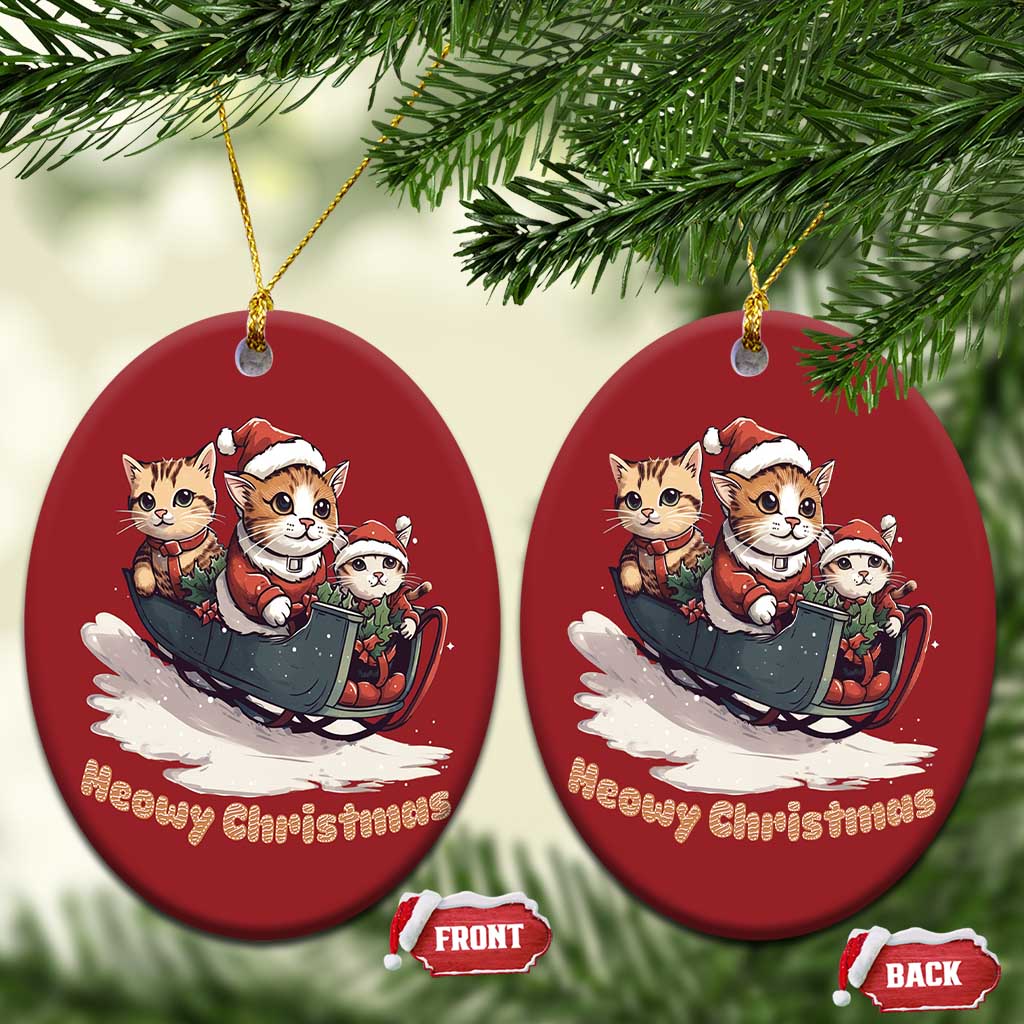 Two red circular cat sleigh Christmas ornaments with “Meowy Christmas” and gold hangers.
