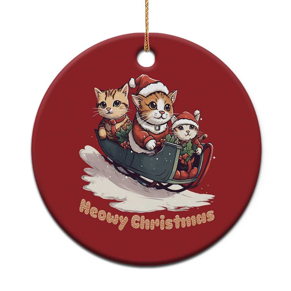 Red circular Christmas ornament with three cute cats in a sleigh, gold hanger loop.