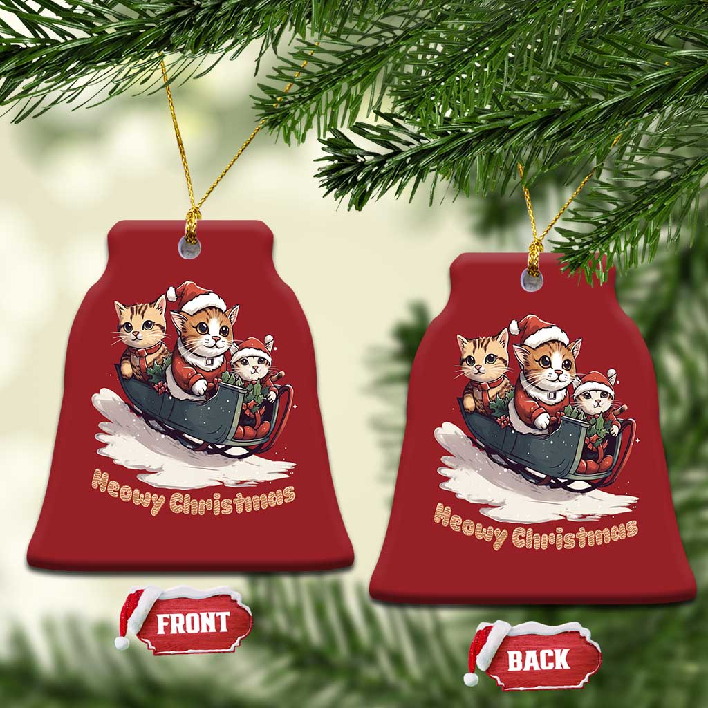 Set of red bell-shaped Christmas ornaments with cute cat sleigh art and gold hangers.