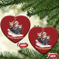 Two red heart-shaped Christmas ornaments with cats in sleigh and gold hanging loops.