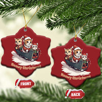 Two red heart-shaped cat sleigh Christmas ornaments on branches, gold hangers visible.