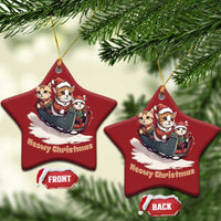 Two red star-shaped Christmas ornaments with cats in sleigh and gold hanger cords.