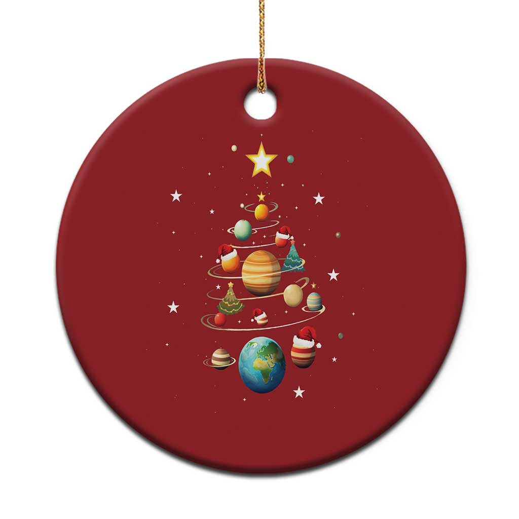 Red round Christmas ornament with solar system and small Christmas tree design, hanging loop