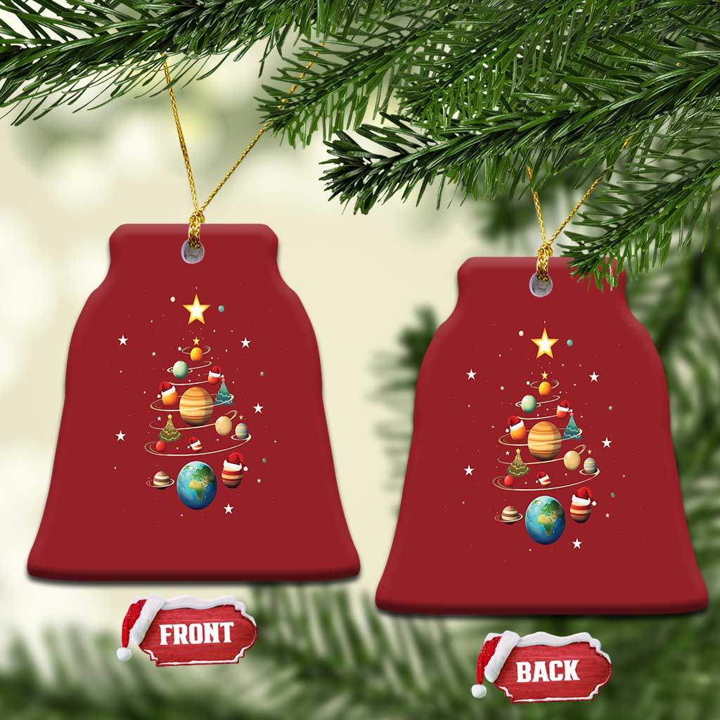 Two red bell-shaped Christmas ornaments with solar system planets and Christmas tree artwork