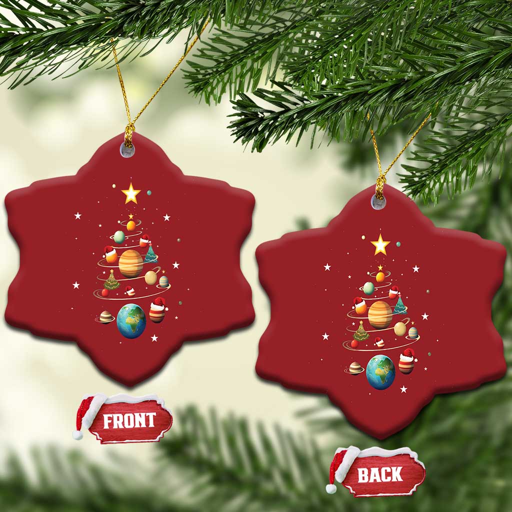 Two red star-shaped Christmas ornaments with solar system planets and Christmas tree graphic