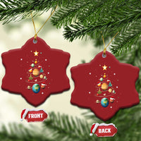 Two red star-shaped Christmas ornaments with solar system planets and Christmas tree graphic