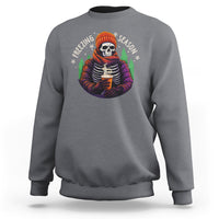 Charcoal gray crewneck sweatshirt with skeleton holding hot cocoa graphic on the chest