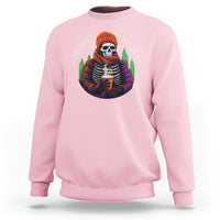 Light pink crewneck sweatshirt with skeleton holding hot cocoa graphic on the chest