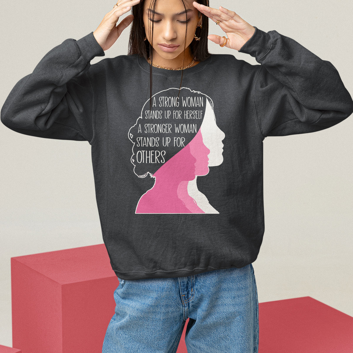 Women’s black crewneck sweatshirt with “A Strong Woman…” text and pink profile graphic