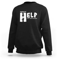 Black sweatshirt with white “HELP” graphic and “Asking for” text on the chest