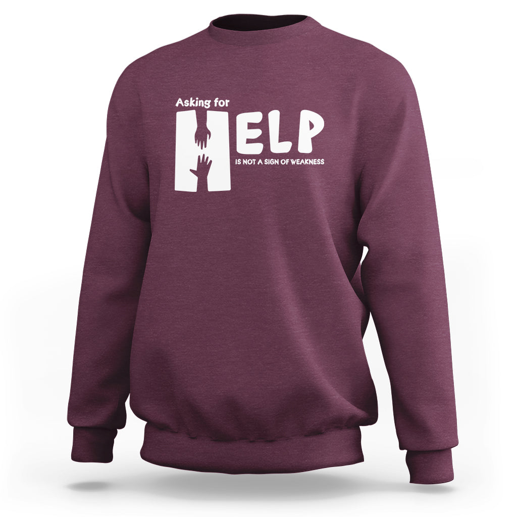 Purple sweatshirt with white “HELP” graphic and “Asking for” text on the chest