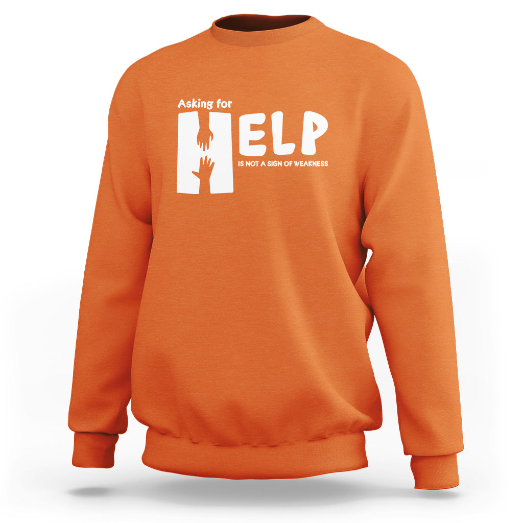 Orange sweatshirt with white “HELP” graphic and “Asking for” text on the chest