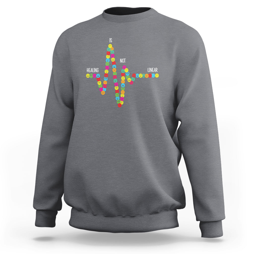 Gray crewneck sweatshirt with colorful cross-shaped text graphic on back