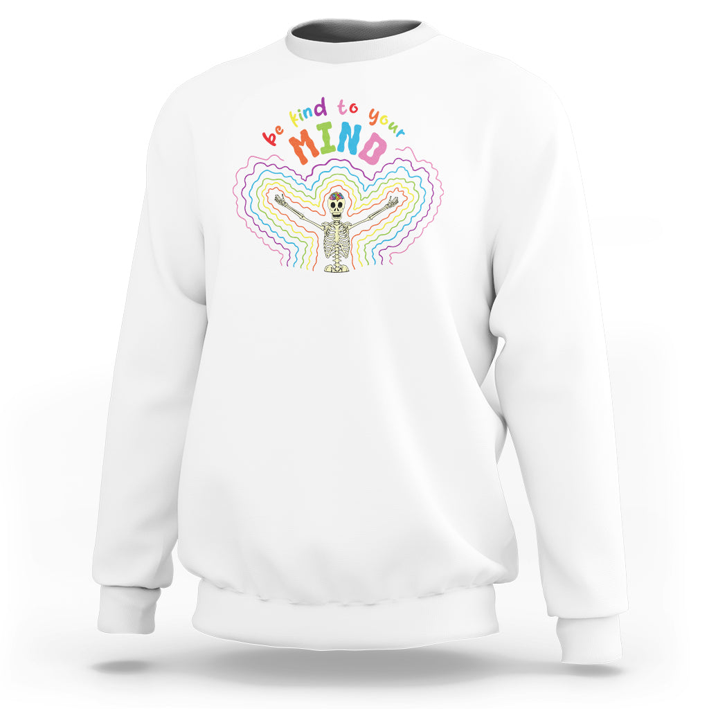 White crewneck sweatshirt with rainbow skeleton 'Be kind to your mind' graphic
