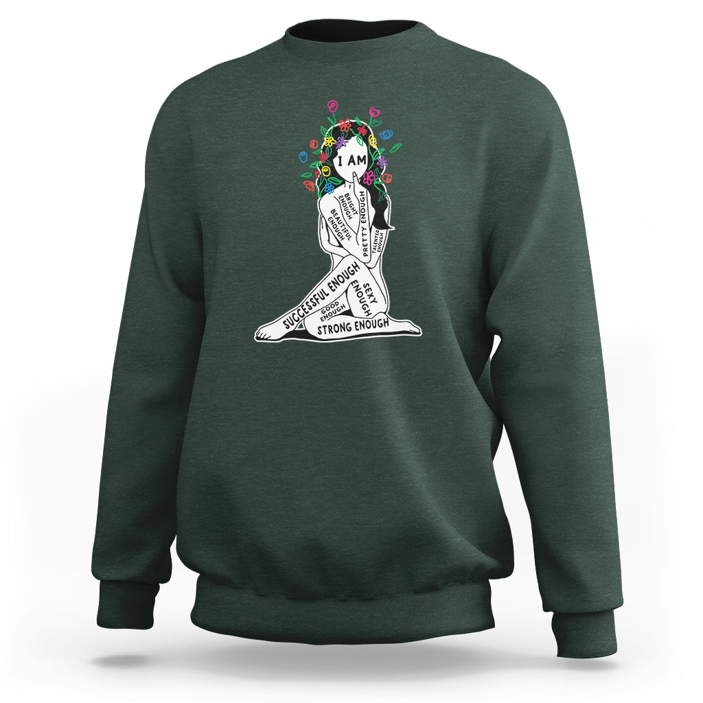 Dark forest green crewneck sweatshirt with colorful “I AM” portrait graphic and text