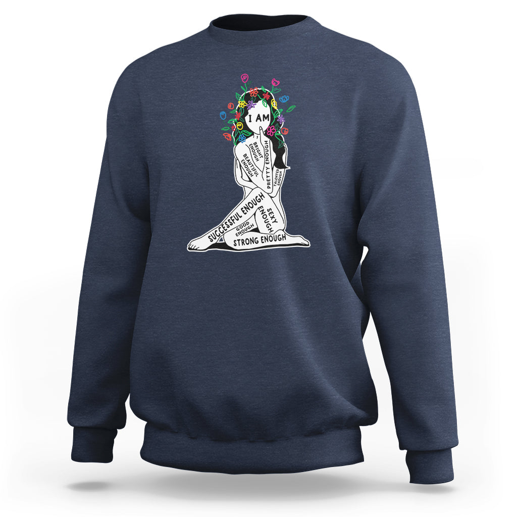 Blue crewneck sweatshirt with colorful “I AM” portrait graphic and motivational quote