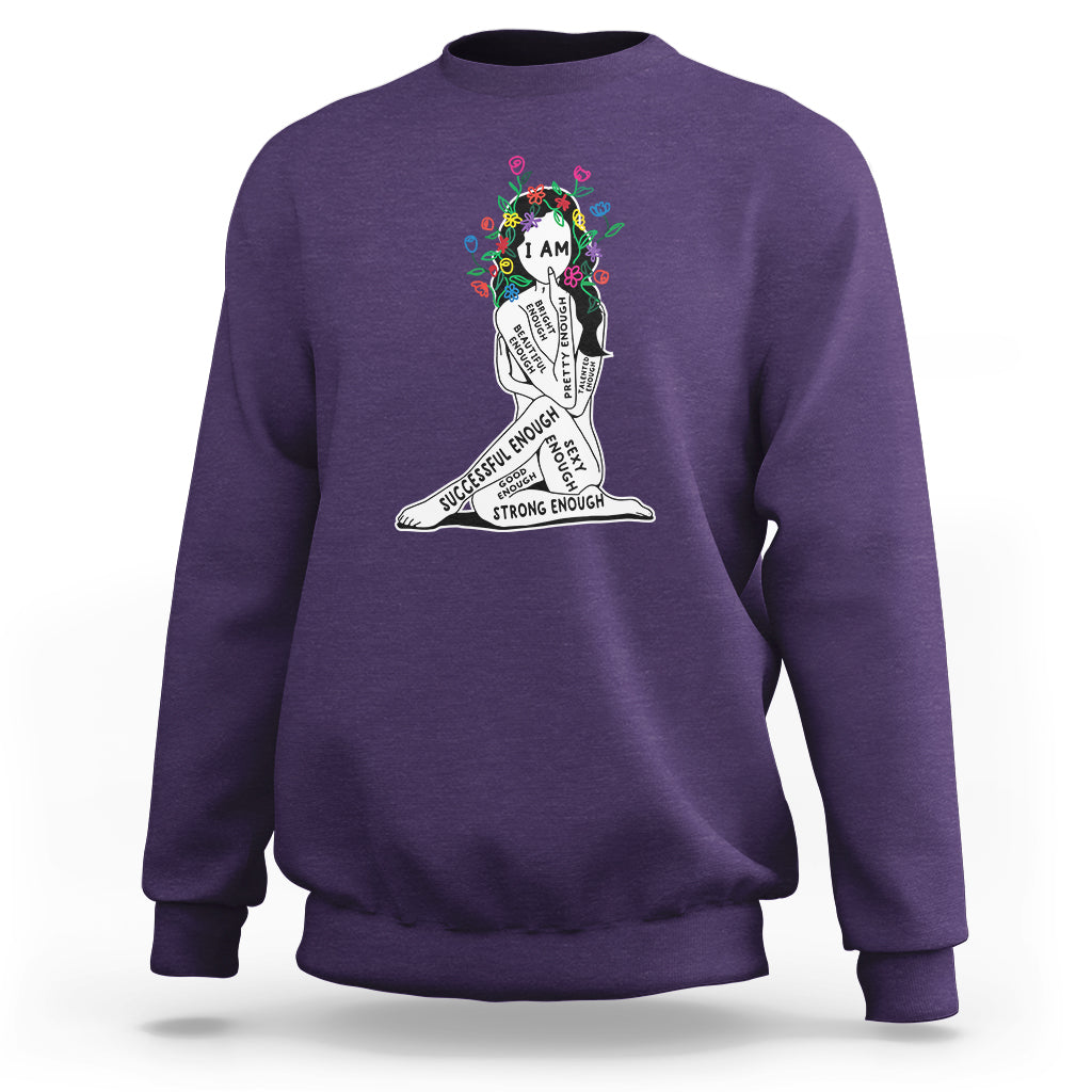 Purple crewneck sweatshirt with colorful “I AM” portrait graphic and motivational text
