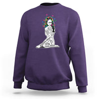 Purple crewneck sweatshirt with colorful “I AM” portrait graphic and motivational text