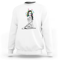 White crewneck sweatshirt with colorful “I AM” portrait graphic and motivational text