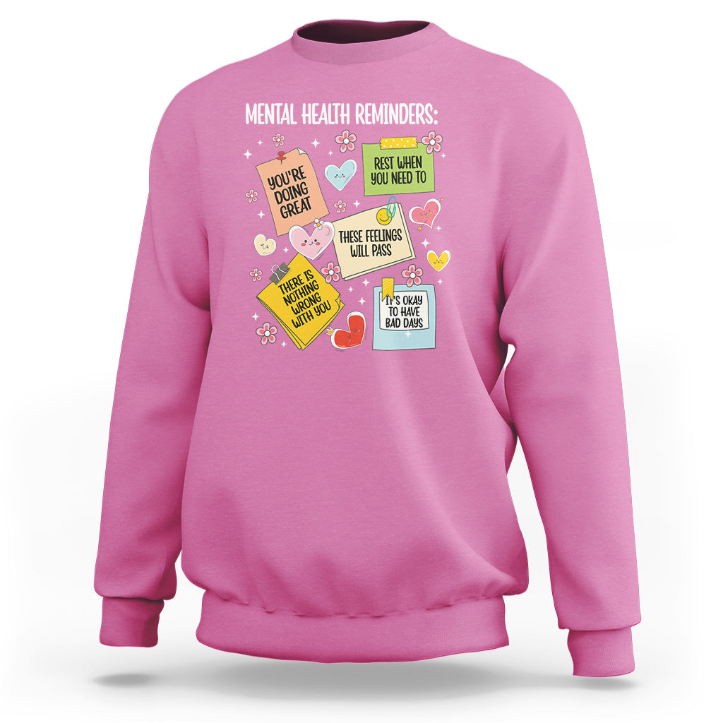 Pink crewneck sweatshirt with colorful mental health reminder quote graphic