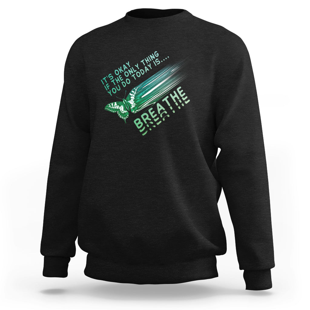 Black crewneck sweatshirt with teal 'breathe' butterfly graphic on chest.