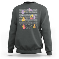 Dark heather sweatshirt with multicolor cats on musical notes graphic