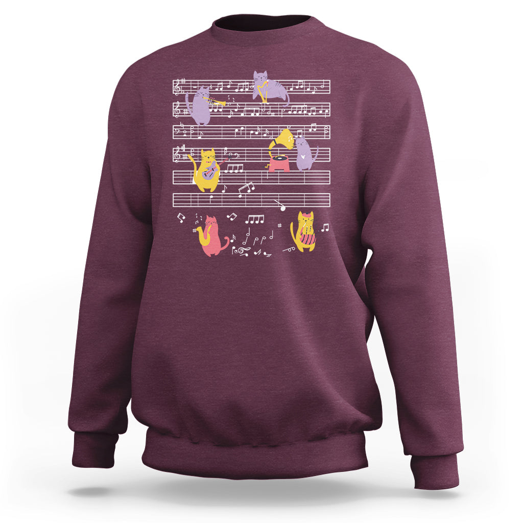 Maroon sweatshirt with multicolor cats on musical notes graphic