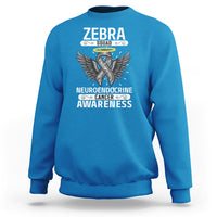 Bright blue crewneck sweatshirt with long sleeves and Zebra Squad awareness graphic on front.