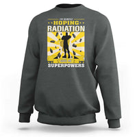 Dark heather crewneck sweatshirt with long sleeves and radiation awareness front graphic.