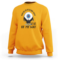 Gold crewneck sweatshirt with blind spot character graphic and “GET OUT OF MY WAY” print