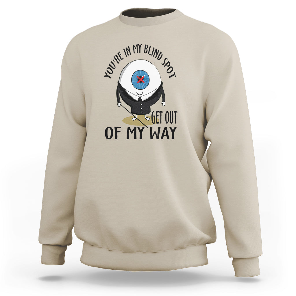 Sand beige crewneck sweatshirt with blind spot character graphic and “GET OUT OF MY WAY”