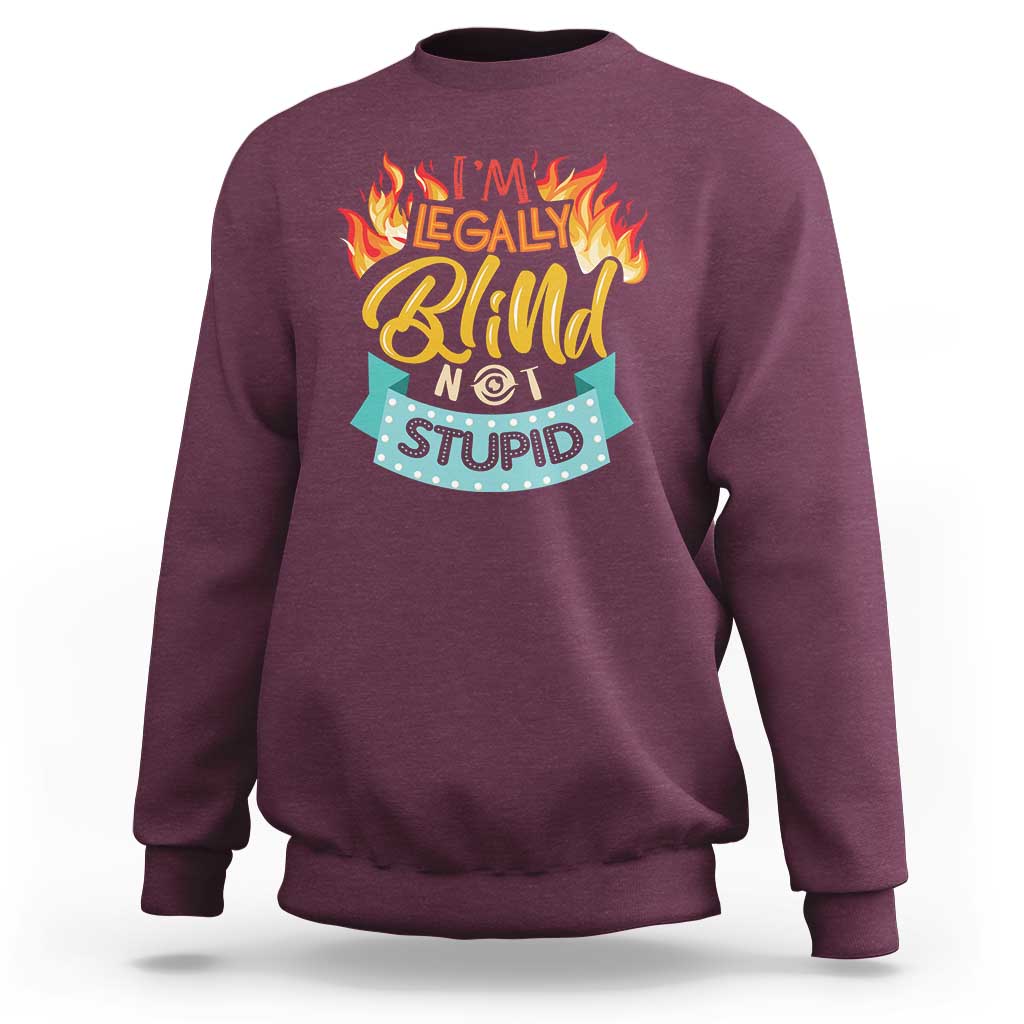 Maroon crewneck sweatshirt with front graphic “I’m legally blind not stupid”