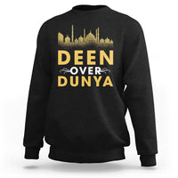 Black crewneck sweatshirt with gold 'DEEN OVER DUNYA' mosque skyline print.