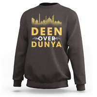 Dark chocolate crewneck sweatshirt with gold 'DEEN OVER DUNYA' mosque skyline print.