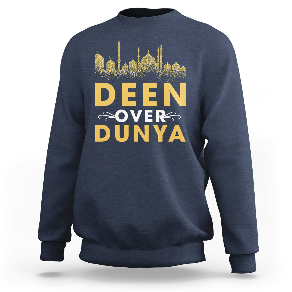 Navy crewneck sweatshirt with gold 'DEEN OVER DUNYA' mosque skyline print.