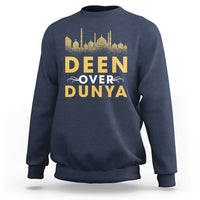 Navy crewneck sweatshirt with gold 'DEEN OVER DUNYA' mosque skyline print.