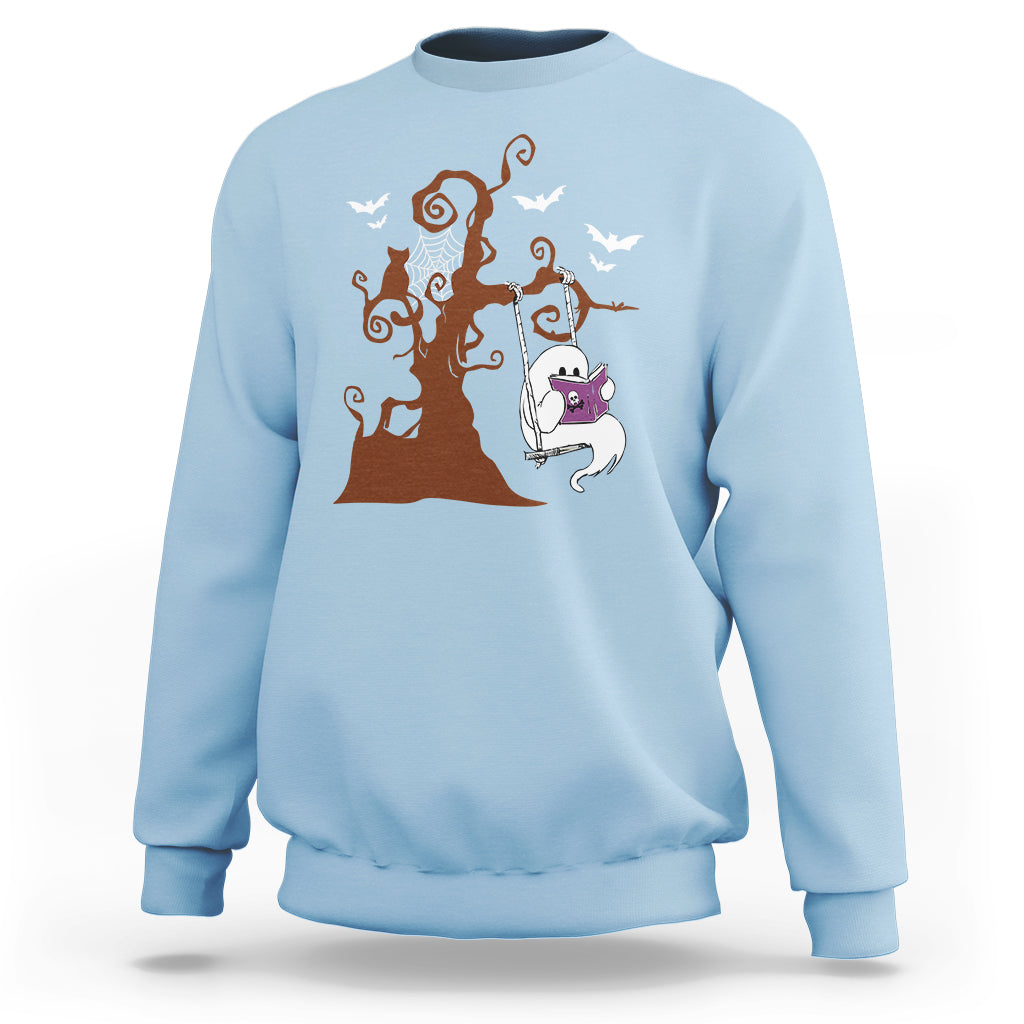 Light blue sweatshirt with orange Halloween tree and cute ghost reading book graphic.