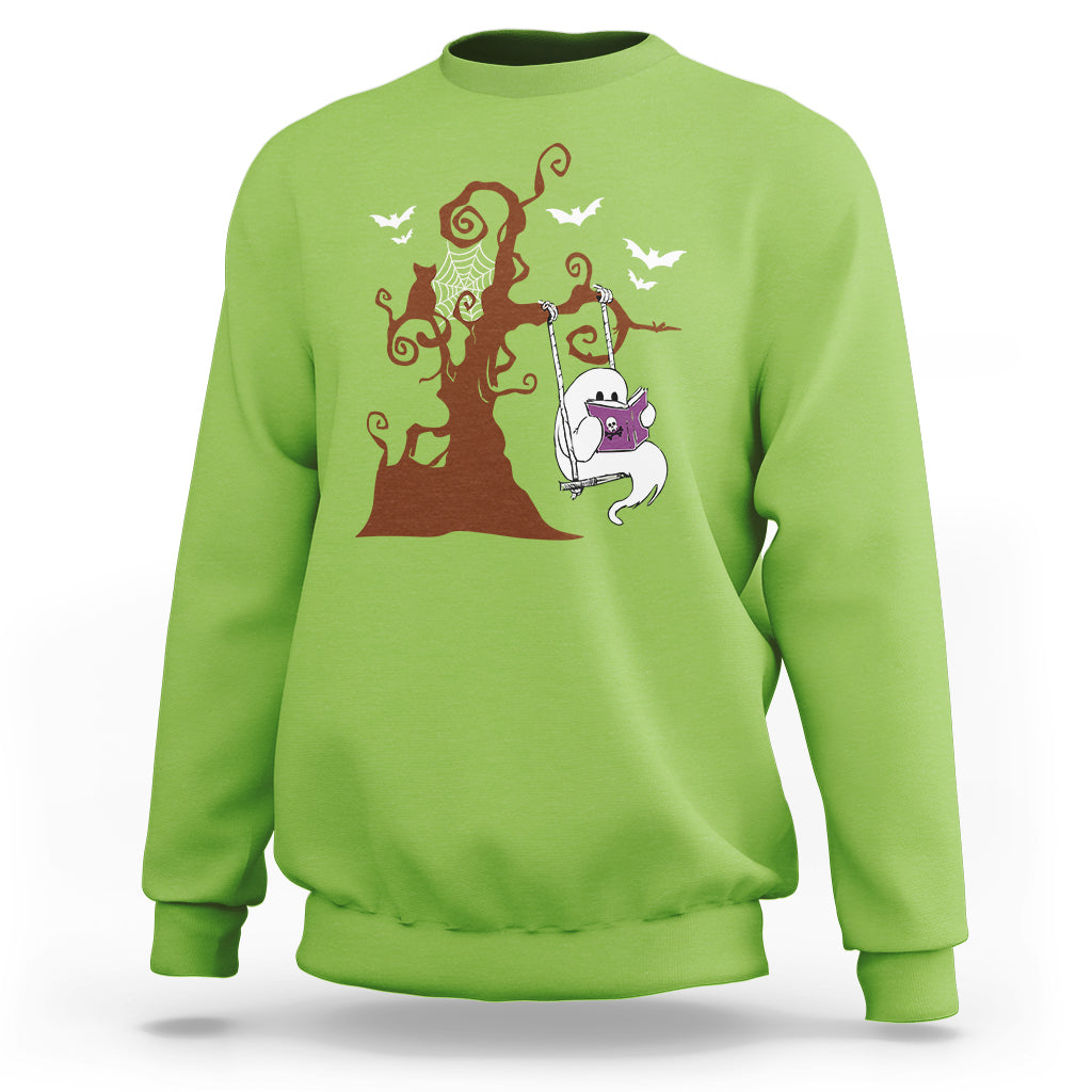 Lime green sweatshirt with orange Halloween tree and cute ghost reading book graphic.