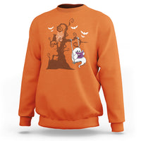 Orange sweatshirt with orange Halloween tree and cute ghost reading book graphic.