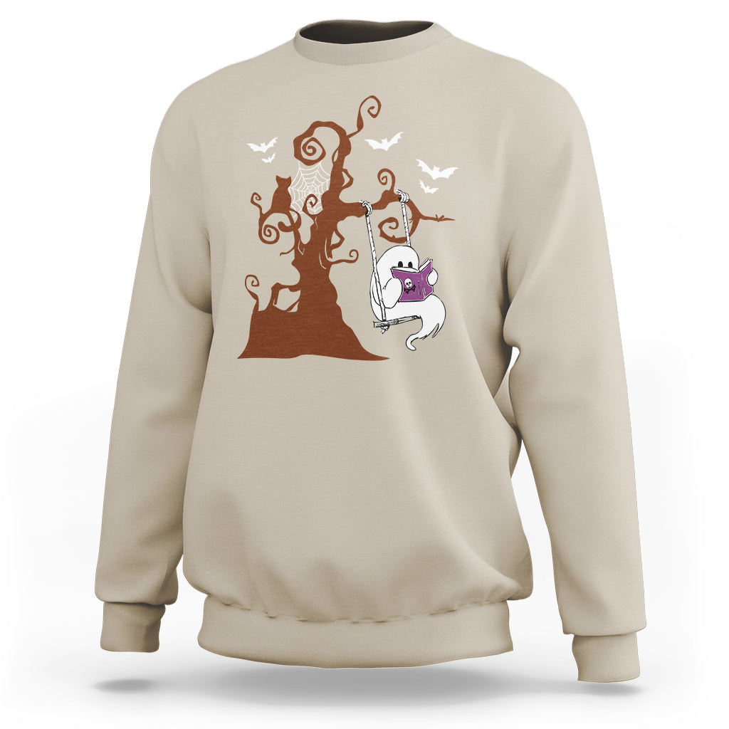 Sand beige sweatshirt with orange Halloween tree and cute ghost reading book graphic.