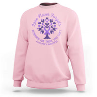 Light pink sweatshirt with purple Alzheimer awareness heart snowflake graphic and text