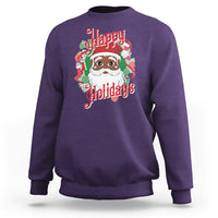 Purple crewneck sweatshirt with colorful Santa face and “Happy Holidays” graphic