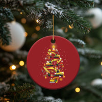Red circular hanging Christmas ornament with yellow construction-vehicle tree and star