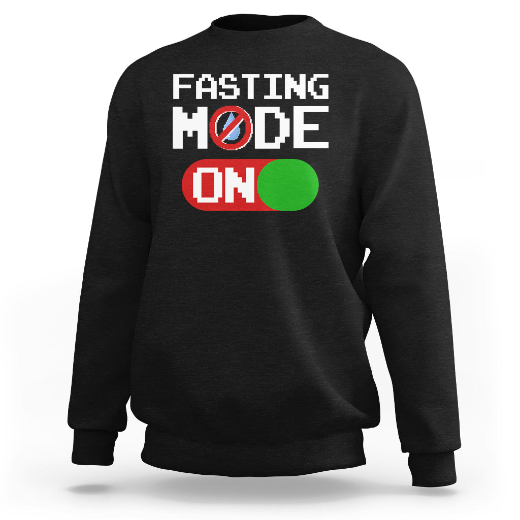Black sweatshirt with 'FASTING MODE ON' graphic on chest