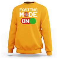 Gold/orange sweatshirt with 'FASTING MODE ON' graphic on chest