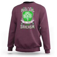 Maroon crewneck sweatshirt with centered clover graphic and slogan print