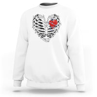 White gothic skeleton sweatshirt with red heart graphic on the front