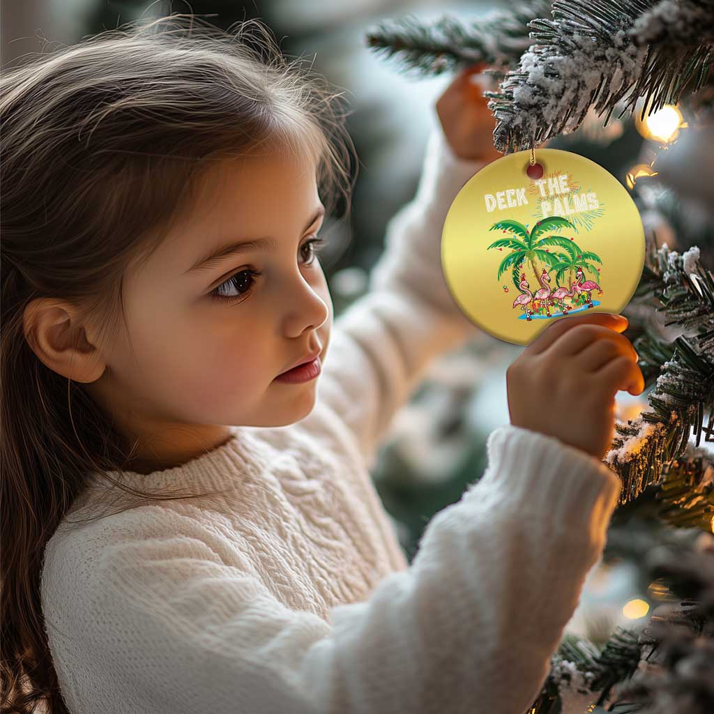 Gold round “Deck the Palms” ornament with flamingo palm design on a Christmas tree