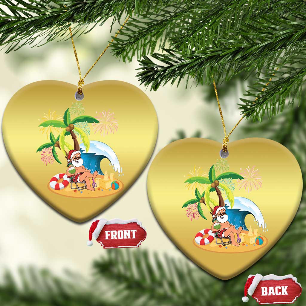 Gold heart-shaped ornament with Santa on beach under palms, front and back tags; hanging.