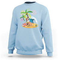 Light blue crewneck sweatshirt with palm tree Santa beach graphic, coconut drink and fireworks
